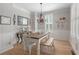 Elegant dining room with hardwood floors, decorative chandelier, and wainscoting at 997 Woodbury Rd, Canton, GA 30114