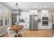 Modern kitchen with stainless steel appliances, white cabinets, hardwood floors and breakfast nook at 997 Woodbury Rd, Canton, GA 30114