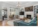Cozy living room with fireplace, built-in shelves, and large windows for natural light at 997 Woodbury Rd, Canton, GA 30114