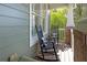 Inviting front porch featuring two rocking chairs with cushions; perfect for relaxing outdoors at 997 Woodbury Rd, Canton, GA 30114