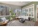 Inviting sunroom with comfortable furnishings and serene views of the surrounding landscape at 997 Woodbury Rd, Canton, GA 30114