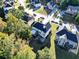 Aerial view of a home with a cozy backyard and a patio with outdoor seating, surrounded by mature trees at 1721 Telfair Chase Way, Lawrenceville, GA 30043