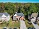 Aerial view of a two-story brick home with a well-manicured lawn and mature trees in a neighborhood at 1721 Telfair Chase Way, Lawrenceville, GA 30043