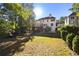 A lush backyard featuring a deck, patio, fire pit, and green lawn at 1721 Telfair Chase Way, Lawrenceville, GA 30043