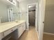 Bathroom showcasing a vanity and a tiled walk-in shower with a glass door and a built in seat at 1721 Telfair Chase Way, Lawrenceville, GA 30043