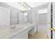 Well-lit bathroom with double sinks, a vanity area, and clean, white cabinetry at 1721 Telfair Chase Way, Lawrenceville, GA 30043