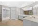 Spacious bathroom featuring double vanity, large mirror, and an open doorway to a closet at 1721 Telfair Chase Way, Lawrenceville, GA 30043