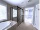 Bright bathroom with a soaking tub, glass shower, and walk-in closet at 1721 Telfair Chase Way, Lawrenceville, GA 30043
