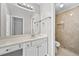 Bathroom vanity with white cabinets, large mirror, and a tiled walk-in shower at 1721 Telfair Chase Way, Lawrenceville, GA 30043