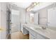 Bright bathroom with a double sink vanity, wooden floors, and large mirror at 1721 Telfair Chase Way, Lawrenceville, GA 30043