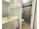 Bathroom with a vanity and a tiled walk-in shower with a glass door and a built in seat at 1721 Telfair Chase Way, Lawrenceville, GA 30043