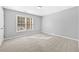 Light-filled bedroom with carpeted floors and a large window, creating a serene atmosphere at 1721 Telfair Chase Way, Lawrenceville, GA 30043