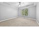 A bright and airy bedroom with large windows and neutral walls and a ceiling fan at 1721 Telfair Chase Way, Lawrenceville, GA 30043