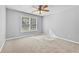 Neutral bedroom features carpet, a ceiling fan, and natural light from a large window at 1721 Telfair Chase Way, Lawrenceville, GA 30043