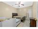 Bedroom features tile flooring, a ceiling fan, and two beds at 1721 Telfair Chase Way, Lawrenceville, GA 30043