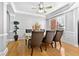 Spacious dining room featuring hardwood floors, tray ceiling, and stylish furniture at 1721 Telfair Chase Way, Lawrenceville, GA 30043