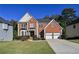 Beautiful two-story brick home with a well-maintained lawn and two-car garage offers classic curb appeal at 1721 Telfair Chase Way, Lawrenceville, GA 30043