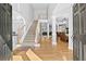 Spacious foyer with hardwood floors, staircase, open floor plan, and elegant columns at 1721 Telfair Chase Way, Lawrenceville, GA 30043