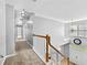 Bright hallway with carpet flooring, wooden railing, and natural light from the front door at 1721 Telfair Chase Way, Lawrenceville, GA 30043