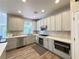 Modern kitchen with stainless steel appliances, light gray cabinets, and stylish backsplash at 1721 Telfair Chase Way, Lawrenceville, GA 30043