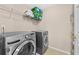 Spacious laundry room with modern washer and dryer, wire shelves, and storage space at 1721 Telfair Chase Way, Lawrenceville, GA 30043