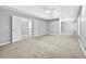 Spacious main bedroom with carpet, a ceiling fan, and double doors to the main bathroom at 1721 Telfair Chase Way, Lawrenceville, GA 30043