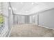 Spacious main bedroom features carpet, a tray ceiling, bright windows, and double doors at 1721 Telfair Chase Way, Lawrenceville, GA 30043