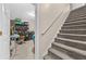 Carpeted staircase beside a storage area with tiled flooring at 1721 Telfair Chase Way, Lawrenceville, GA 30043