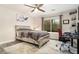 Cozy bedroom featuring a ceiling fan, decorative artwork, a workstation, and a large window at 2112 Palmyra Dr, Marietta, GA 30067