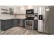 Kitchen featuring stainless steel appliances, two-tone cabinets, and white subway tile backsplash at 2112 Palmyra Dr, Marietta, GA 30067