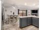 Open kitchen and dining area featuring wood-look floors, stainless appliances and fireplace in living room at 2112 Palmyra Dr, Marietta, GA 30067