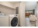 Bright laundry area with modern washer and dryer, plus doorway view to a cozy living space at 2112 Palmyra Dr, Marietta, GA 30067