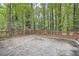 Private back patio surrounded by lush trees offers a peaceful outdoor retreat at 2184 Pemberton Sw Rd, Atlanta, GA 30331