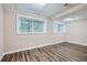Basement with wood grain flooring and two windows allowing natural light at 2184 Pemberton Sw Rd, Atlanta, GA 30331