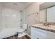 Bright bathroom featuring a shower/tub with white tile and marble countertops at 2184 Pemberton Sw Rd, Atlanta, GA 30331