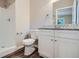 Bright bathroom with a vanity with granite countertop and a shower with white tiles at 2184 Pemberton Sw Rd, Atlanta, GA 30331