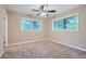 Neutral bedroom featuring plush carpeting, a ceiling fan, and bright natural light from the window at 2184 Pemberton Sw Rd, Atlanta, GA 30331