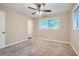 Bedroom featuring plush carpeting, a ceiling fan, and a sunlit window at 2184 Pemberton Sw Rd, Atlanta, GA 30331