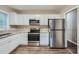 Modern kitchen with stainless steel appliances, white cabinets, and granite countertops at 2184 Pemberton Sw Rd, Atlanta, GA 30331