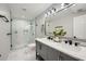 Modern bathroom offers double sink vanity, marble floors and walk-in shower with glass door at 2772 Dunnington Cir, Atlanta, GA 30341