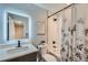 Bathroom features sleek fixtures, a shower-tub combo, and a decorative shower curtain at 2772 Dunnington Cir, Atlanta, GA 30341