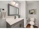 Powder room featuring modern fixtures, stylish mirror, and gray vanity at 2772 Dunnington Cir, Atlanta, GA 30341