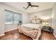 Bedroom features a decorative bed frame, hardwood floors and a large window for natural light at 2772 Dunnington Cir, Atlanta, GA 30341