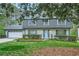 Charming two-story home featuring a lovely blue door, trimmed hedges, and a well-maintained lawn at 2772 Dunnington Cir, Atlanta, GA 30341
