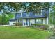 Inviting two-story home with a well-kept lawn, trimmed hedges, and a blue door, perfect for curb appeal at 2772 Dunnington Cir, Atlanta, GA 30341