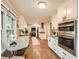 Bright kitchen boasts white cabinetry, stainless appliances, hardwood floors and eat-in breakfast nook at 2772 Dunnington Cir, Atlanta, GA 30341