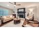 Bright living room with fireplace, ceiling fan and hardwood floors at 2772 Dunnington Cir, Atlanta, GA 30341