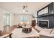 Cozy living room with a decorative fireplace, ceiling fan, and hardwood floors at 2772 Dunnington Cir, Atlanta, GA 30341