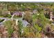An aerial view shows the neighborhood with houses surrounded by lush trees in a wooded, green setting at 6060 Masters Club Dr, Suwanee, GA 30024