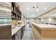 Open basement bar with modern cabinets, wine rack, sink and stainless refrigerator offers ample entertaining space at 6060 Masters Club Dr, Suwanee, GA 30024